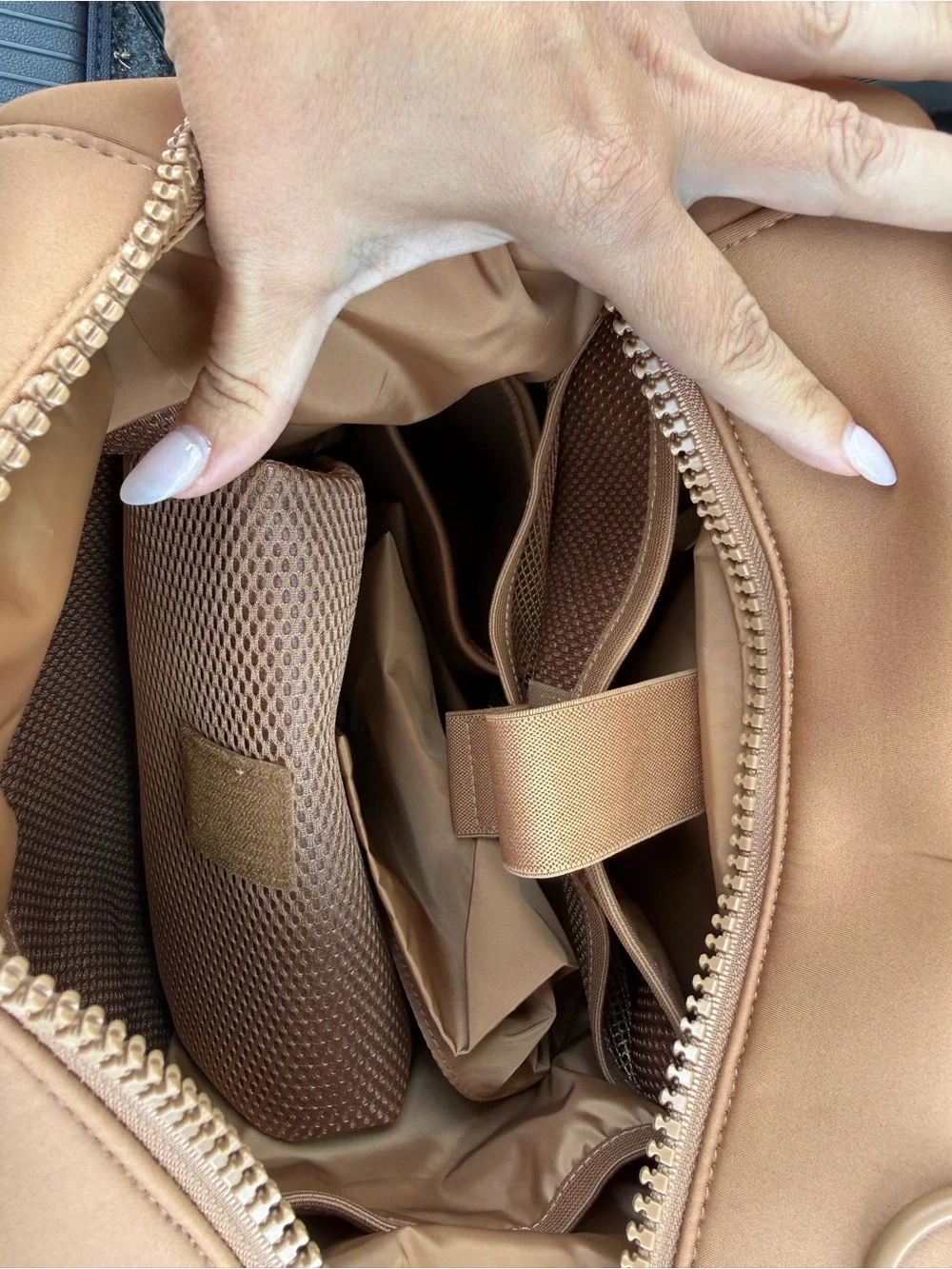 This is a Dagne Dover Dakota Neoprene Backpack in the color Camel.